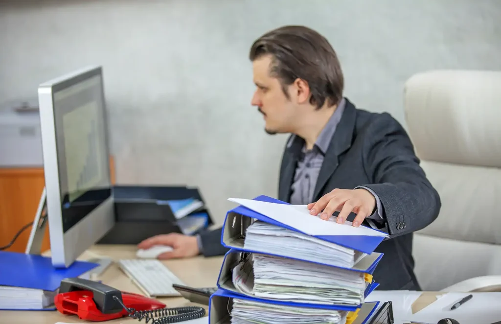 Business owner working through financial and compliance reporting at a desk