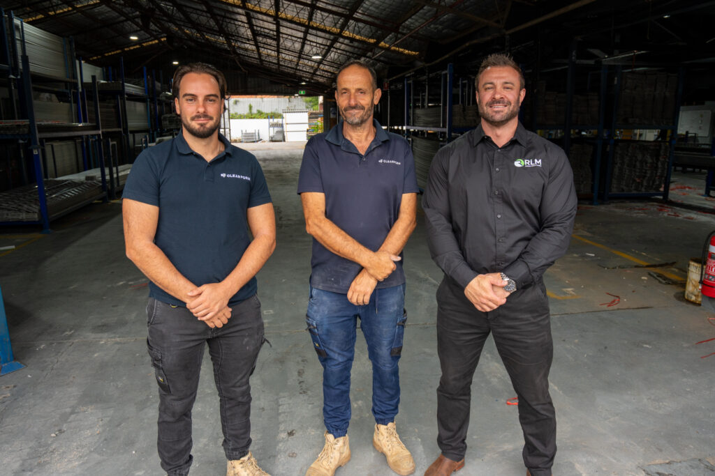 Three RLM Consult Certify Comply team members in a client warehouse