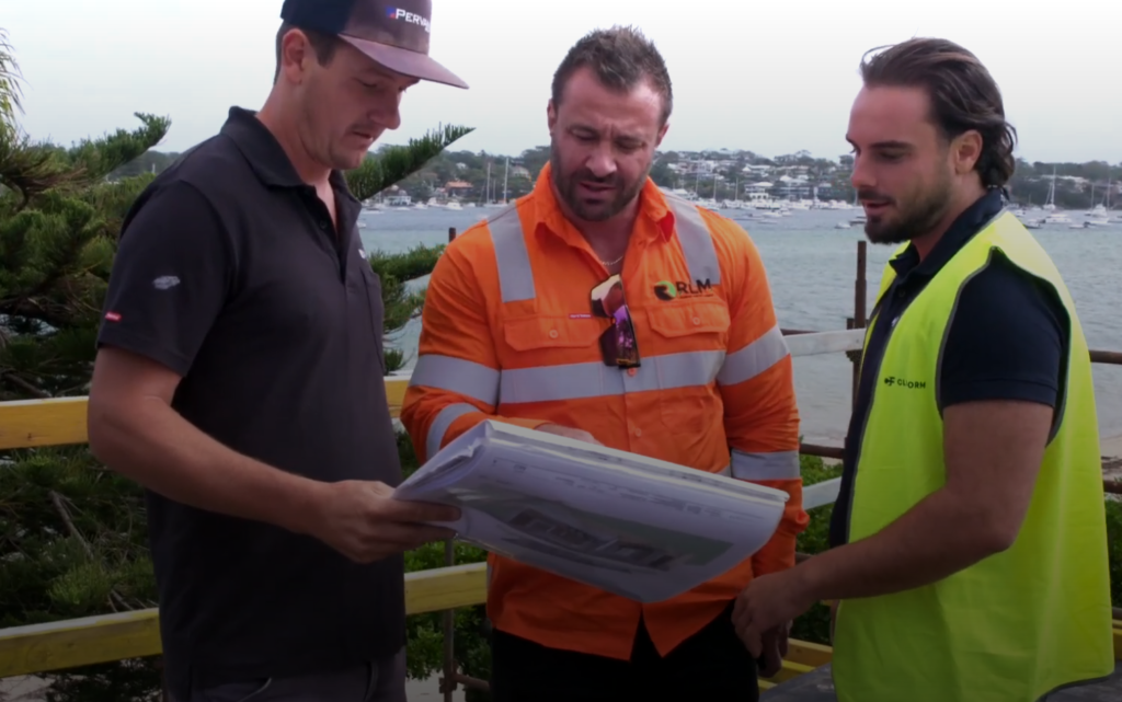 RLM consultants reviewing drawings with a contractor on a construction site